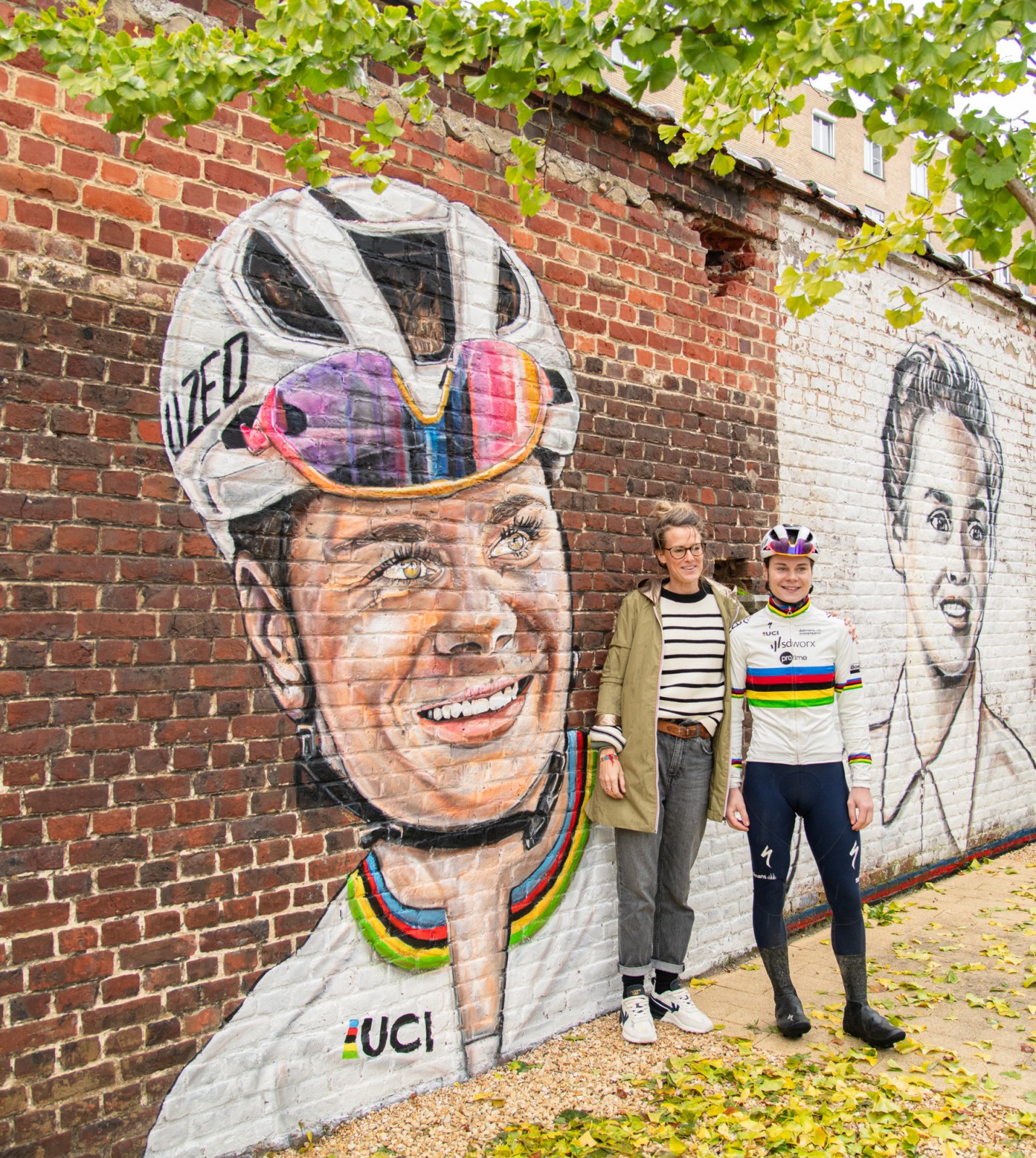 Julie Vercruysse en Lotte Kopecky poseren bij de mural