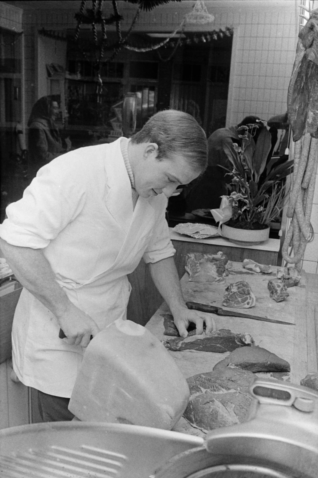 Eric Leman works at the local butcher's shop, 1971